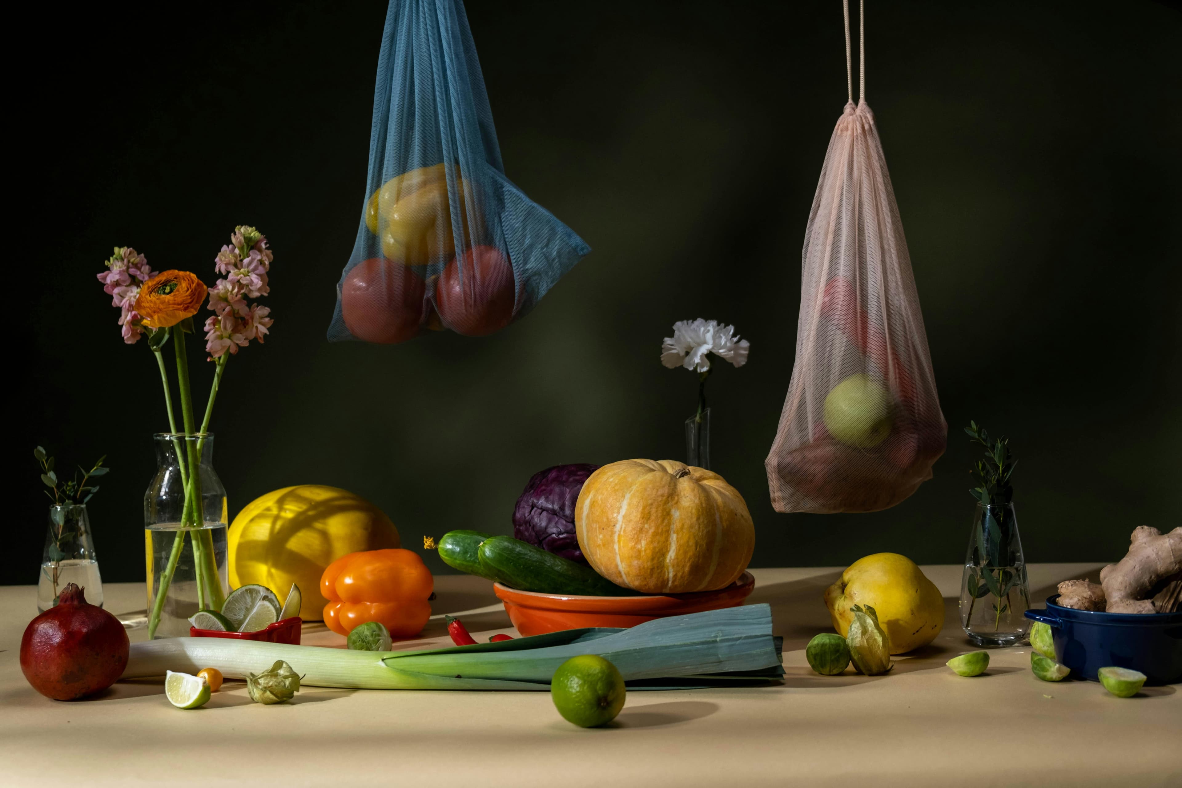Fresh fruits and vegetables on a table, arranged with hands